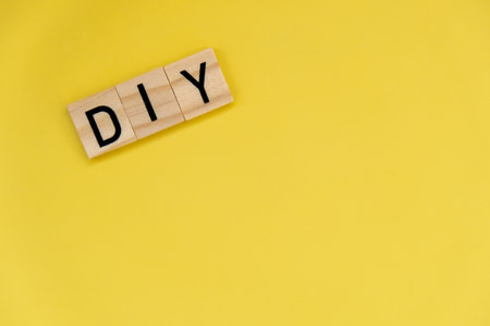 DIY Do It Yourself inscription on yellow background. Handmade home repair decorating handicraft. Tactile creative hobby conceptの写真素材