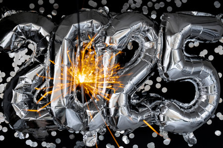 Happy new year 2025 metallic balloons with confetti and sparkler firework Bengal lights on dark...