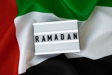 Lightbox with text RAMADAN on UAE flag background concept. Greeting card advertisement....