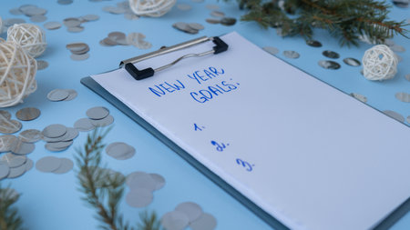 Handwritten new year resolutions aims goals on paper notepad. Preparation for New Year. Planning and...