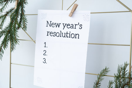 Vision board with NEW YEARS RESOLUTION aims goals on paper note. Preparation for New Year. Planning and setting goals for personal developmentの写真素材