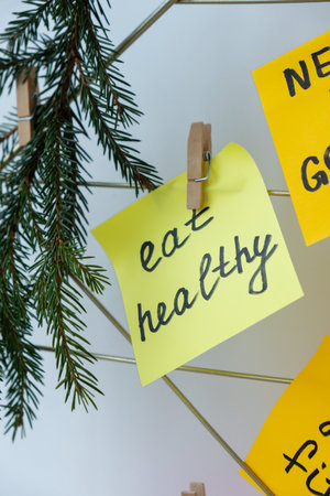EAT HEALTHY goal on Vision board with new year resolutions aims on sticky notes. Preparation for New Year. Planning and setting goals for personal developmentの写真素材