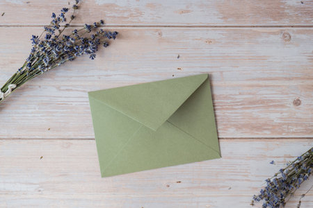 Empty green envelope paper template mock up. Copy space for your text. Lavender flower. Greeting or invitation card blank with envelopeの写真素材