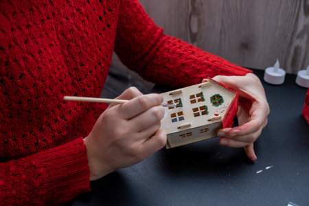 Sustainableminded Christmas cozy atmospheric festive decor in modern scandinavian home handmade decoration. Tutorial for making do it yourself craft wooden houses. Seasonal activity for kidsの写真素材