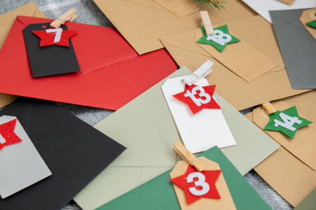 Traditional twenty four days advent calendar before Christmas holidays. Numbers on envelopes Plastic...