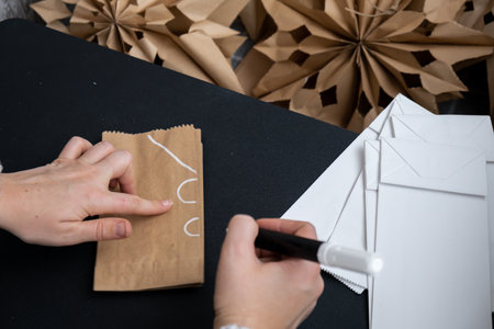 Master class of making craft paper snowflakes for conscientious Christmas decor. Sustainable celebration minimal responsible DIY holiday project. Step by stepの写真素材