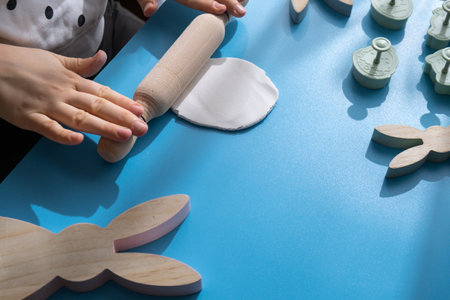 Unrecognizable artist do it yourself air dry clay crafts for Easter holiday. Decoration gift idea Handmade children craft. Step by step instruction of painting, pressing figuresの写真素材