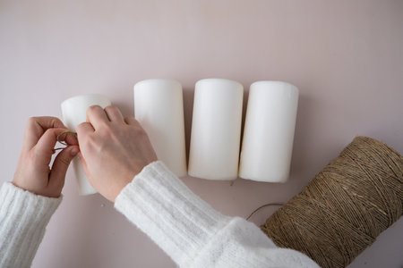 Step by step instruction of making handmade Christmas advent four weeks candle calendar. Female hands creating craft homemade decor. New year celebration. Winter holidaysの写真素材