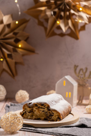 Homemade Christmas traditional cake pie with marzipan nuts and dried fruits pastry dessert stollen. Winter holidays season atmosphere. Delicious tasty composition home table settingの写真素材