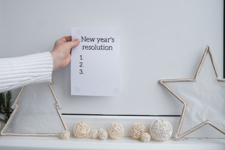 Unrecognizable woman creating vision board with Motivational paper note NEW YEARS RESOLUTION. Goals setting concept. Strategy for self development improvement. Inspirational Planning better healthier lifeの写真素材