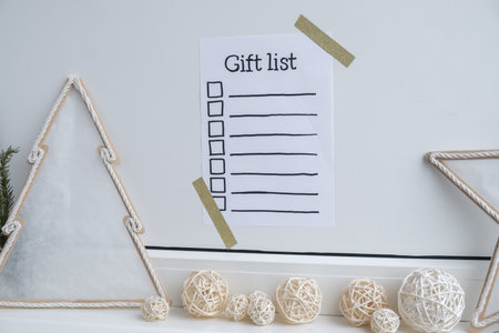 Preparation for winter holidays. GIFT LIST text on paper note. Celebration gifts and presents preparing Natural zero waste homemade Christmas decor. Happy new yearの写真素材