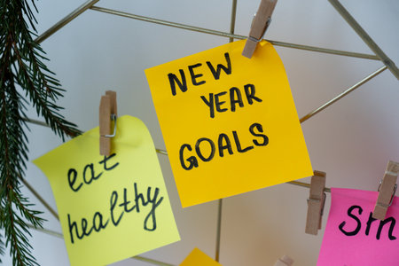 Action board new years resolutions on colorful sticky notes. Making promises for new year, setting goals. Dream yearの写真素材