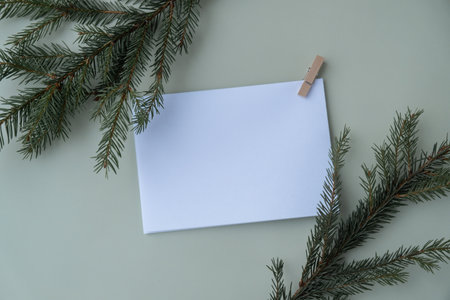 Empty paper letter envelope note Copy space Christmas mockup for lettering art drawing with fir branches on pastel green background. Letter to Santa Claus concept. Flat layの写真素材