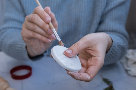 Unrecognizable artist do it yourself air dry clay crafts for Christmas tree decor holiday. Decoration gift idea Handmade children craft. Step by step instruction of paintingの写真素材