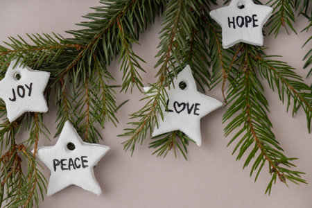 Christmas star with words RISEN HOPE JOY PEACE DREAM LOVE WONDER Group of air dry clay handmade Christmas decor on beige background. Children air dry clay activity handicraft idea. Preparing for Christmas holiday decorating. Modern organic design minimalistic plastic free sustainableの写真素材