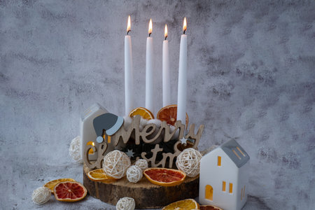Merry Christmas wooden message New year and Christmas preparation. Four-week advent candles on table. Handmade eco-friendly decor. Sustainable Christmas decoration. Copy spaceの写真素材