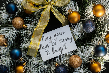 Christmas handmade wreath made of festive decorations paper note with MAY YOUR DAYS BE MERRY AND BRIGHT text. Winter holiday celebration greeting card. top viewの写真素材