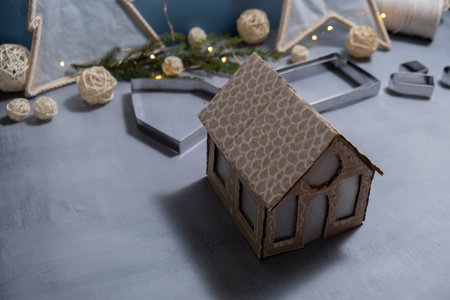 Cardboard House Gift Christmas idea. Do it yourself instructions eco-friendly decoration. Zero waste Making handmade presents children's diy projects. Holiday family time. Creative activityの写真素材