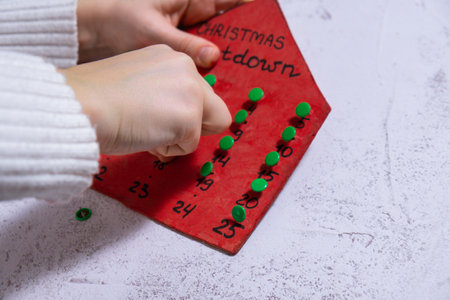 Wooden Christmas advent calendar house Sustainable preparation Diy process of making handmade decoration. Step by step activity for children. Inclusive and responsible stress relief holiday hobby. Conscious celebrationの写真素材