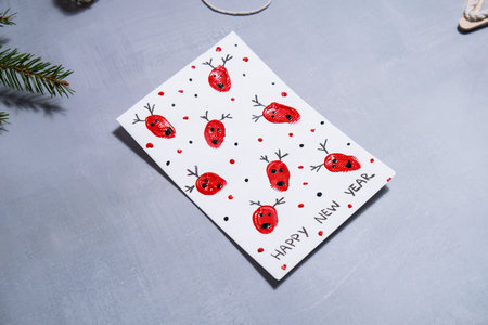 Reindeer fingerprints Storytelling of creating craft Christmas greeting card holiday present. Tactile hand-on activity. Master class progress of creative me-made gifts. Seasonal domestic life micro moment hobby.の写真素材