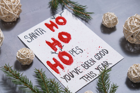 Unrecognizable woman preparing craft Christmas greeting card holiday present. Tactile hand-on...