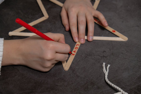 Ice cream sticks Christmas star Sustainable preparation Diy process making handmade decoration. Step by step activity for children. Inclusive and responsible stress relief holiday hobbyの写真素材