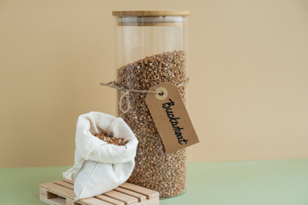 Raw buckwheat porridge in sustainable natural packaging. Refillable systems. Gluten free cereals. Health gut benefits. Concept of alternative whole spelt grain ingredient. Vegetarian diet recipes. Plant-based lifestyle. Copy space Protein richの写真素材