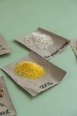 Refillable raw corn porridge with text in paper examples. Refill product format eco-friendly living. Whole spelt grain species. High protein fiber-rich vegan plant based food ingredient. Gluten free superfood healthy nutritional dietaryの写真素材