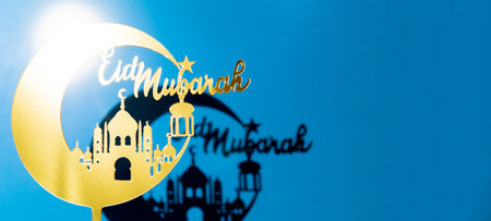 Crescent moon with mosque. Traditional Islamic holiday greetings Eid Mubarak. Ramadan Kareem concept background. Creative light and shadows sunset lamp lantern. Islamic holiday poster Eid-Ul-Adha festivalの写真素材