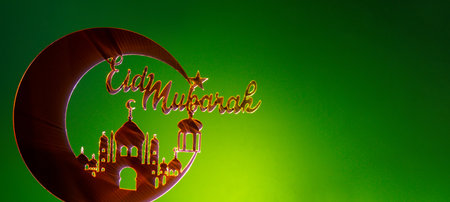 Crescent moon at top of mosque. Eid Mubarak text creative conceptual poster design for advertising branding. Mock up template for greeting card postcard. Ramadan Kareem background. Traditional muslim holidayの写真素材
