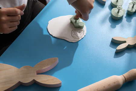 Workshop cutting figures Creator is using white air dry clay for making decor to EASTER holiday. Creating hobby recreation activity that involves fingers. DIY craftingの写真素材