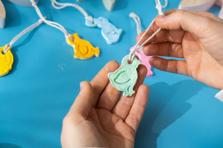 Creator is using white air dry clay for making decor to EASTER holiday. Creating hobby recreation activity that involves fingers. DIY craftingの写真素材