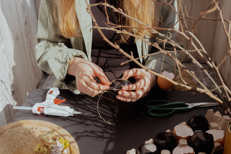 Female hands making egg shell handmade decoration for Easter holiday. Tutorial master class storytelling. Zero waste sustainable eco-friendly me made decor. Minimalisticの写真素材