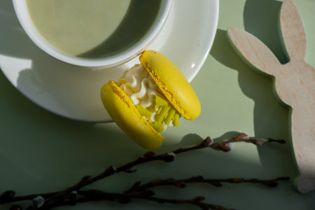 Easter bunny holiday decor. Nutrient-rich matcha drink with macaron dessert and trendy deep shadows on soft colored background. Morning beautiful breakfast present gift idea. Vibrant creative colors. Natural energy giversの写真素材