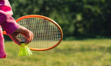 Unrecognizable woman playing with Wooden badminton rackets and shuttlecocks soft focus concept. Copy...