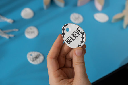 Workshop writing word BELIEVE on EASTER clay egg Unrecognizable artist do it yourself air dry clay crafts for Easter holiday. Decoration gift idea Handmade children craft. Step by step instruction of painting, pressing figuresの写真素材