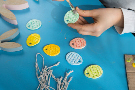 Master class of coloring Creator is using white air dry clay for making decor to EASTER holiday. Creating hobby recreation activity that involves fingers. DIY craftingの写真素材