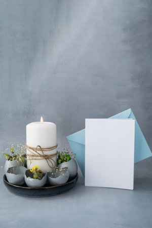 White empty paper note template mock up postcard copy space Easter holiday decoration from sustainable materials egg shell decor with candle. Diy do it yourself step by step instruction. Gift present idea Crafting preparationの写真素材