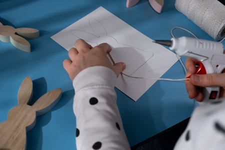 Easter bunny made of rope using hot glue. Diy process of making handmade greeting cards. Step by step activity for children. Inclusive and responsible stress relief holiday hobbyの写真素材