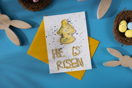 Handmade greeting card with message HE IS RISEN written in beautiful handwriting. Gesture shows...
