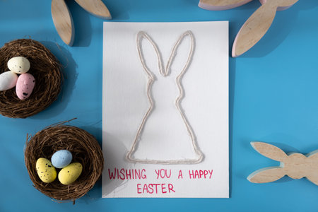 Handmade greeting card with EASTER bunny HAPPY EASTER written in beautiful handwriting. Gesture shows excitement and joy for the upcoming event. Springtime holiday gift present zero cost ideas. Creative artの写真素材