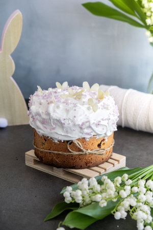 Homemade traditional Easter cake pastry bakery. Festive spring table setting decoration with fresh flowers eggs. Easter family dinner or breakfast ideaの写真素材