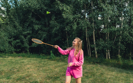 Young woman playing with Wooden badminton rackets and shuttlecocks concept. Copy space Summer outdoor activities. Staycation leisureの写真素材