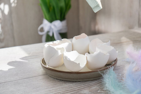 Unrecognizable woman creating Easter holiday decoration from sustainable materials egg shell. Diy do...