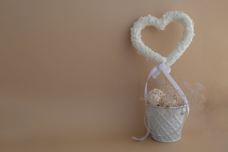 Symbol of love beautiful flower petals in heart shape as present gift in beige background. Creative concept of St Valentines day celebration, weeding romantic date or anniversary. Copy spaceの写真素材