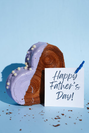 Happy Fathers Day saying caption on greeting card Delicious fresh croissant topped with colorful...