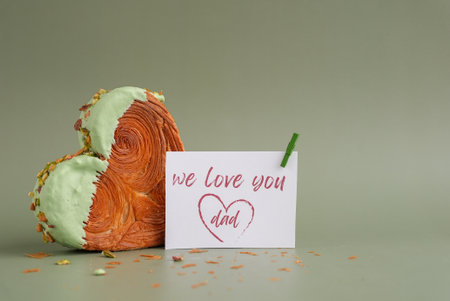 Holiday card Delightful and vibrant heartshaped pastry croissant treat, beautifully topped with colorful frosting nut galore. Mock up template copy space. Food experimentation viral dessert creativeの写真素材