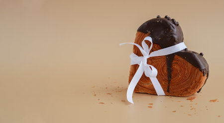 Present gift tied bow holiday Valentines Day birthday celebration Heart shaped dark chocolate...