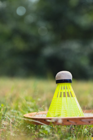 Badminton racket and shuttlecock lie on green grass. Outside recreation and fresh air. Healthy lifestyle nature connection sport summer activities. Stress relief hobbyの写真素材