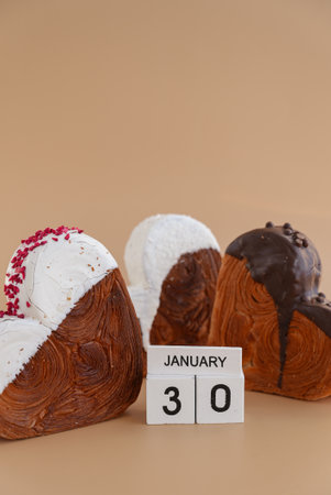 Calendar date 30 January national croissant day greeting card Delicious fresh croissant topped with colorful flavor Ganache. Creation unique heart shape bakery. Puff pastry holiday love gift present ideaの写真素材